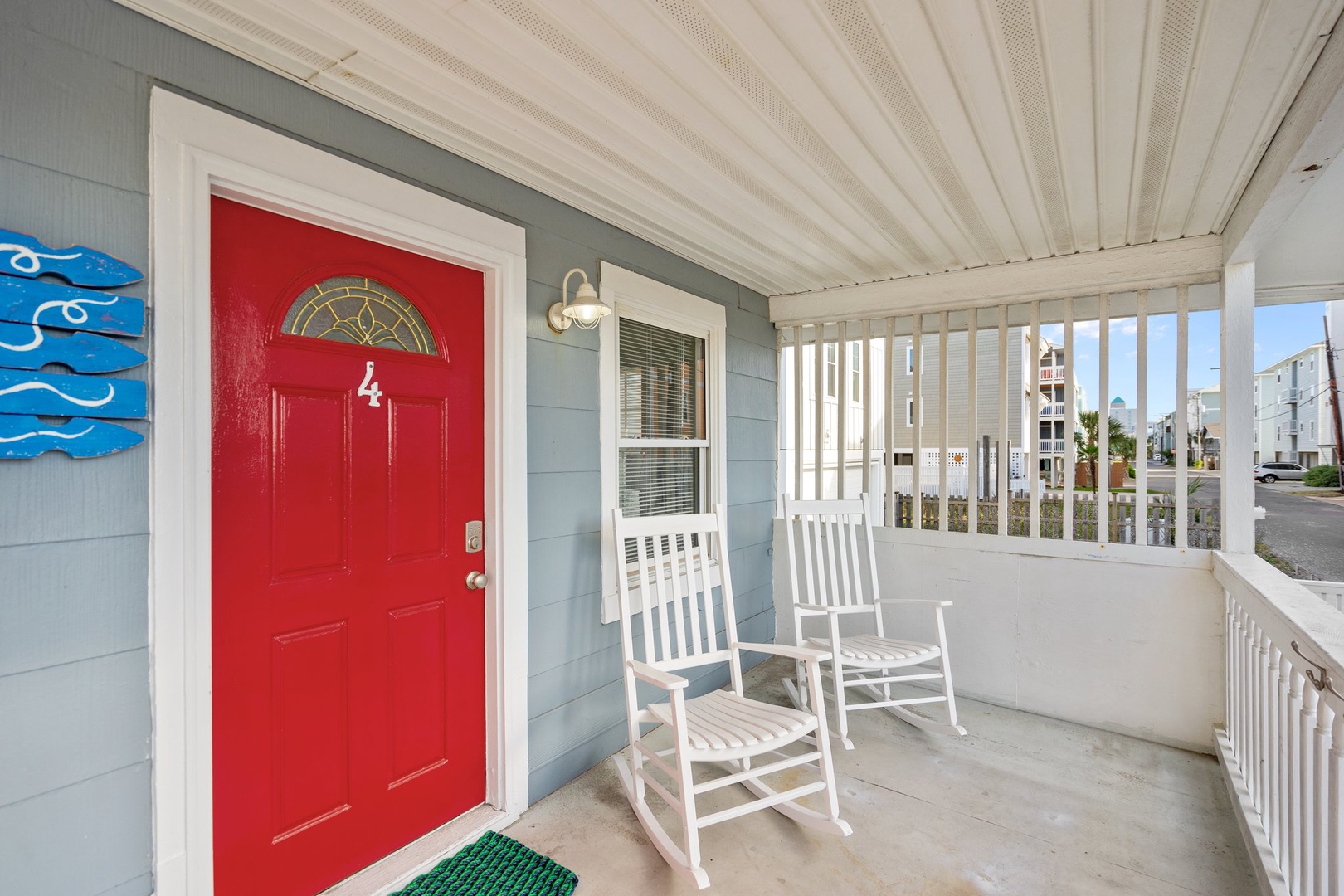 Relax on your private covered porch with rocking chairs, perfect for morning coffee or evening unwinding after beach days.