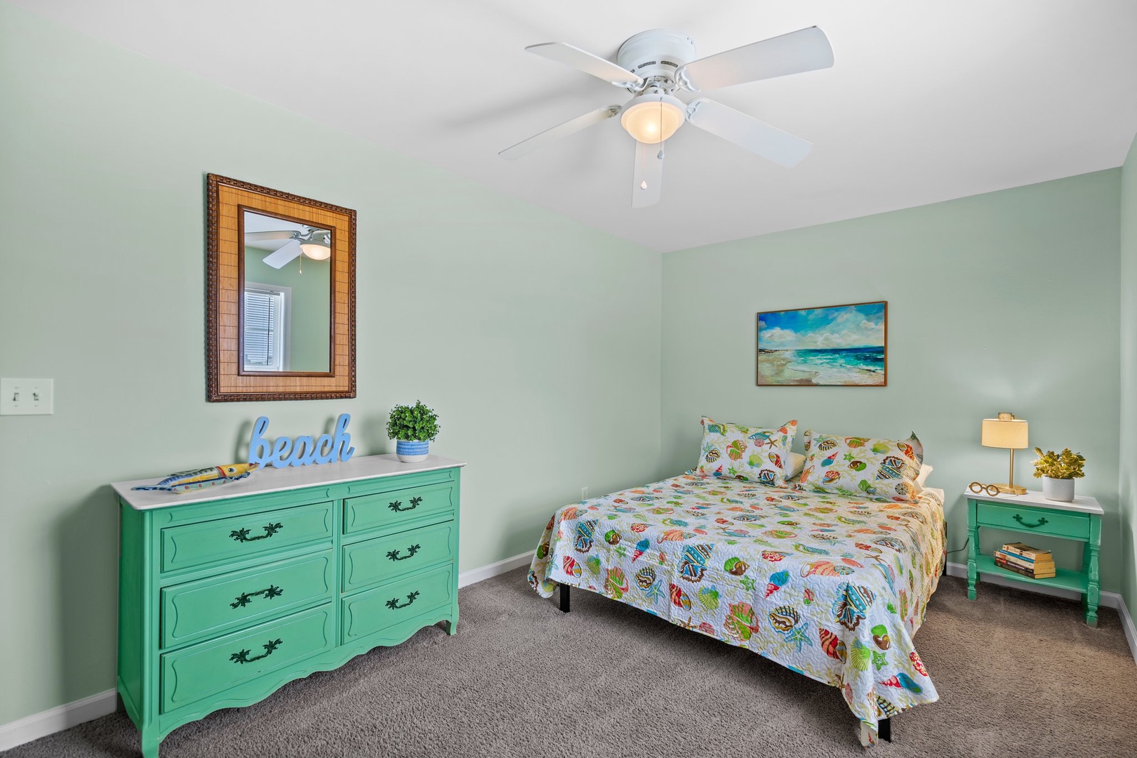 Drift off in this soothing coastal-themed bedroom, where sea-green furniture and cheerful beach bedding create your perfect seaside escape.