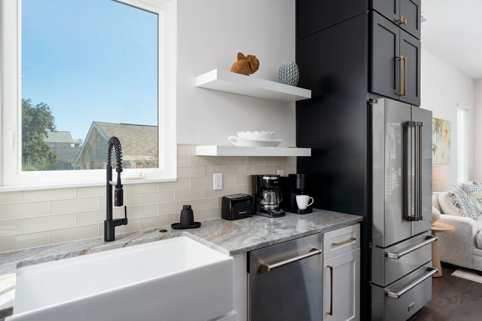Your sleek kitchen features premium appliances, granite counters, and a charming coffee station for perfect mornings.