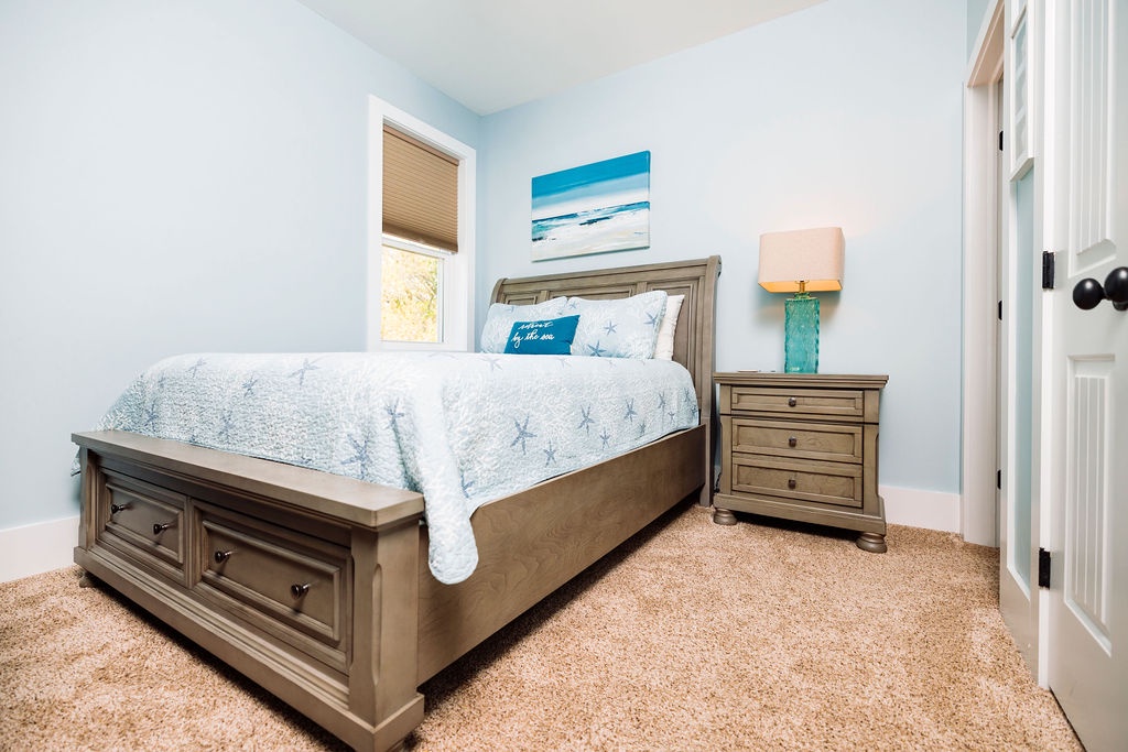 Drift into peaceful sleep in your coastal-themed bedroom, where soft blues and thoughtful touches create your perfect seaside retreat.