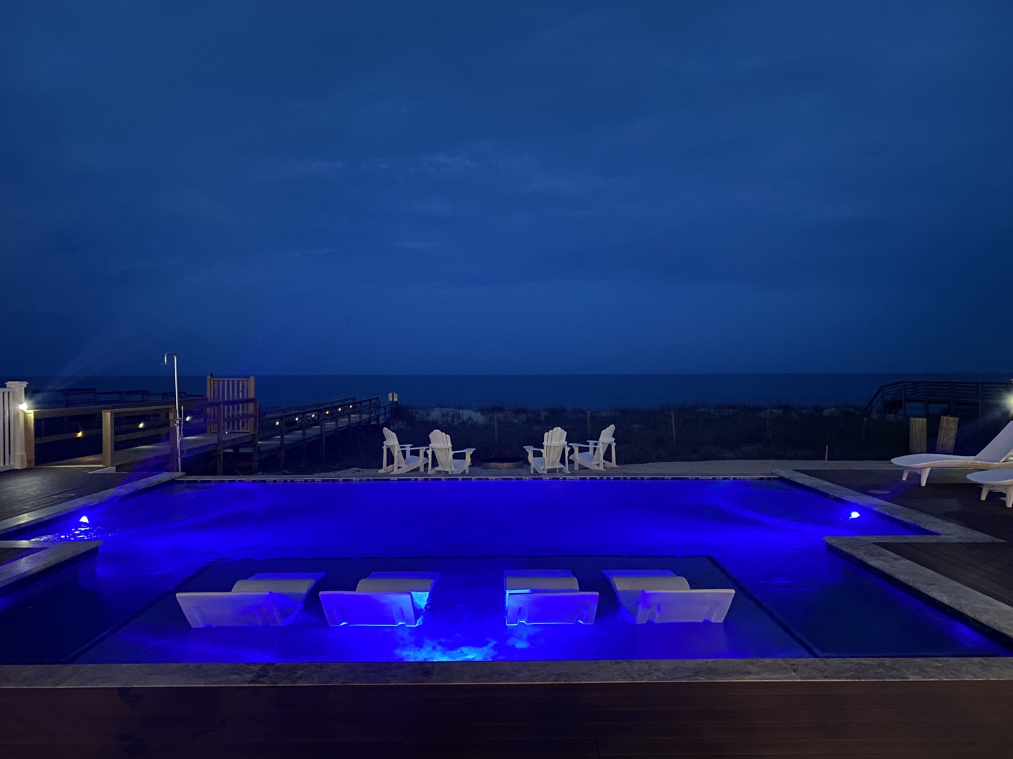 Slip into your own private pool sanctuary, where vibrant blue lighting transforms your evening swim into pure magic.