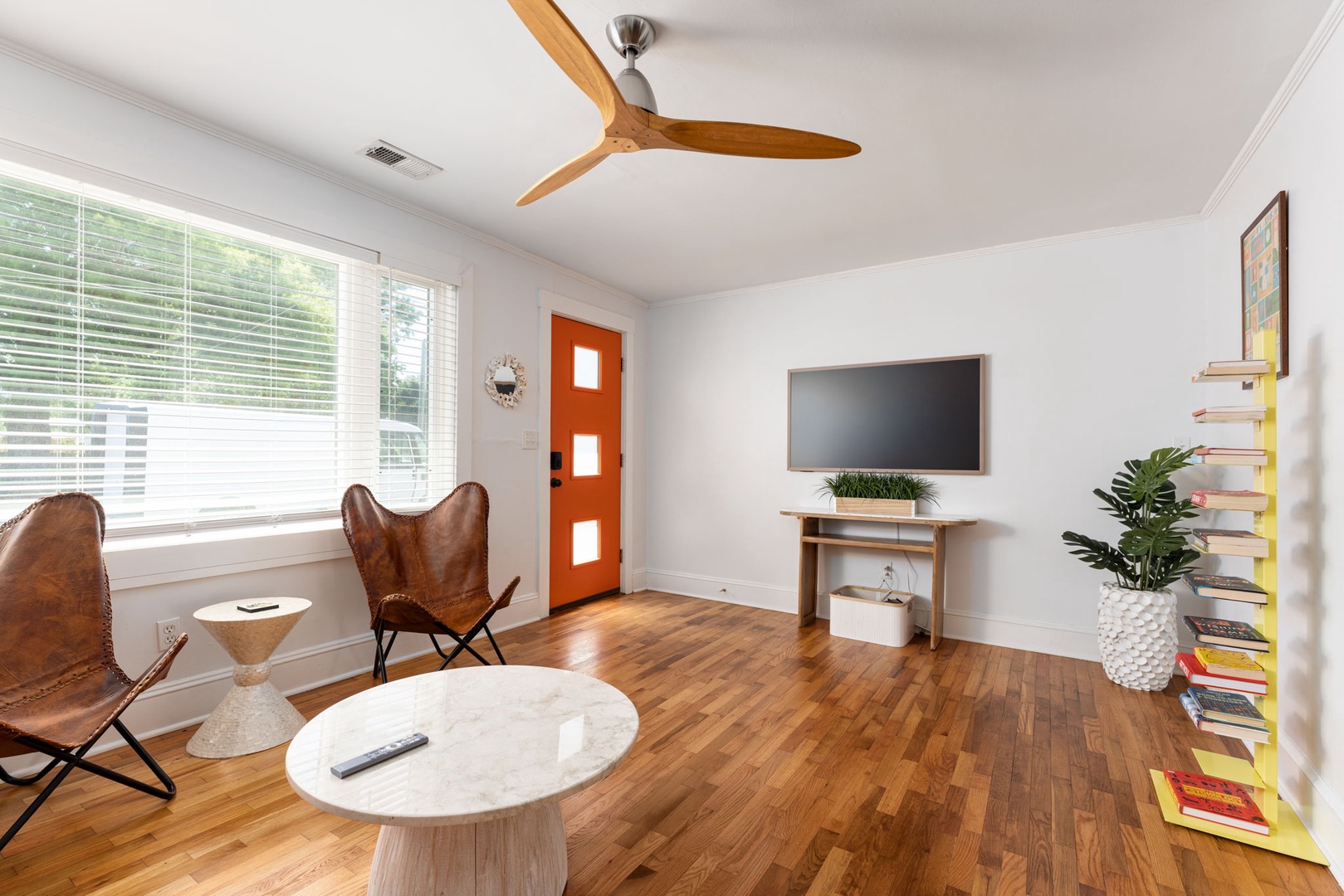 Unwind in your stylish living room with modern leather chairs and smart TV for cozy movie nights.