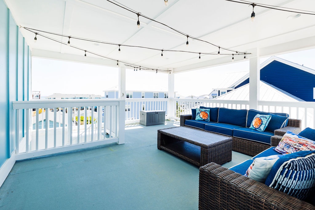 Unwind on your private covered terrace with plush seating and twinkling lights overhead while enjoying coastal views.