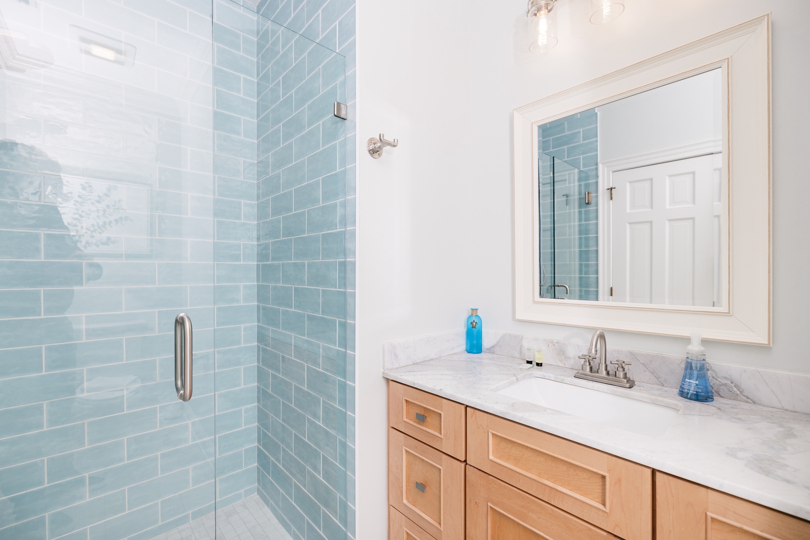 Refresh in your pristine bathroom with spa-like tranquility, featuring a spacious glass shower and elegant vanity for your daily rituals.