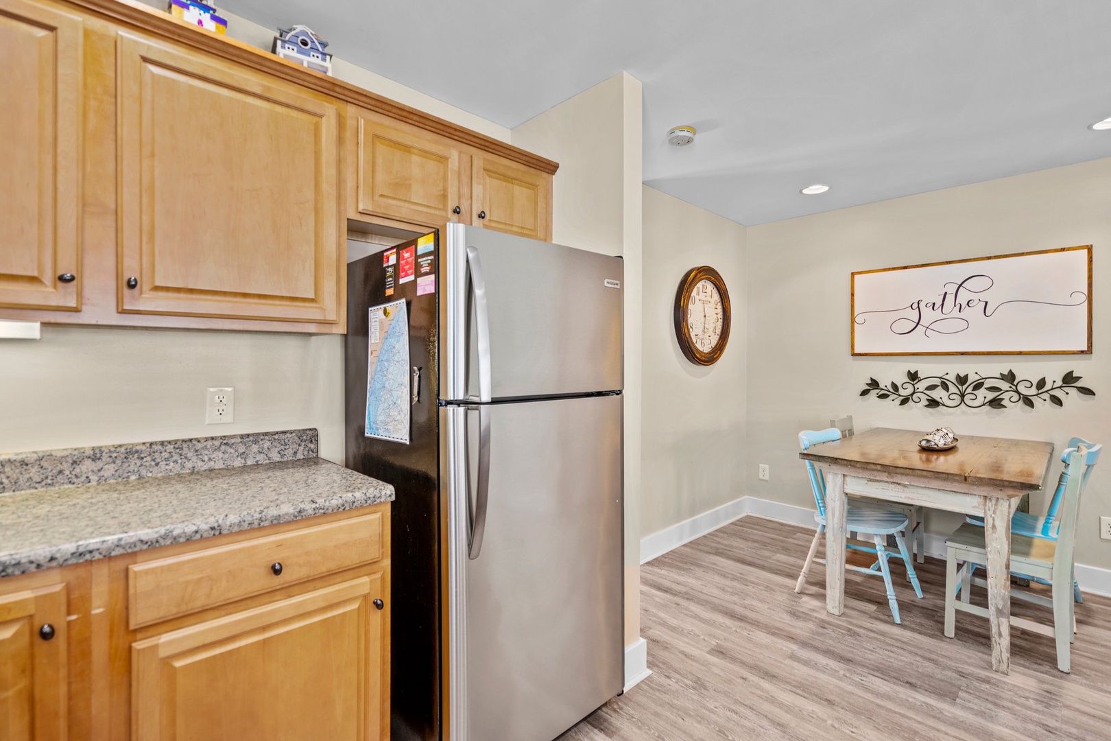 Your fully equipped kitchen opens to a charming dining nook where you'll gather for meals around the rustic table.