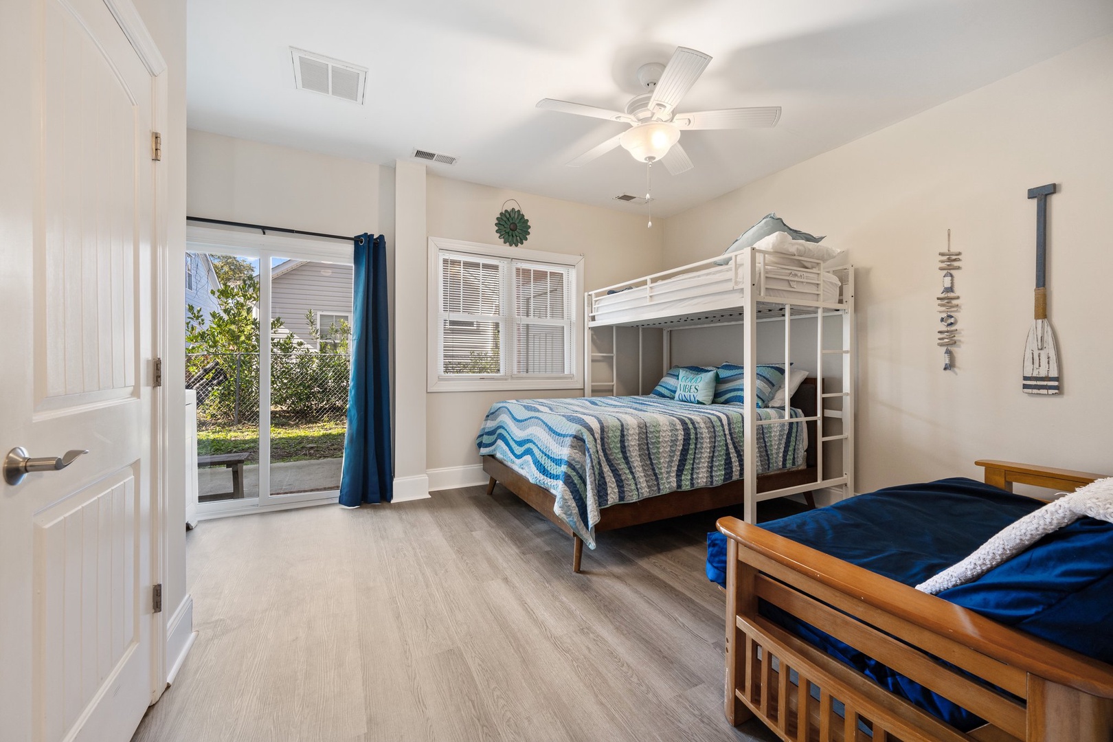 Your kids will love this bright bedroom with bunk beds and twin bed, plus sliding door access to the backyard for easy outdoor play.