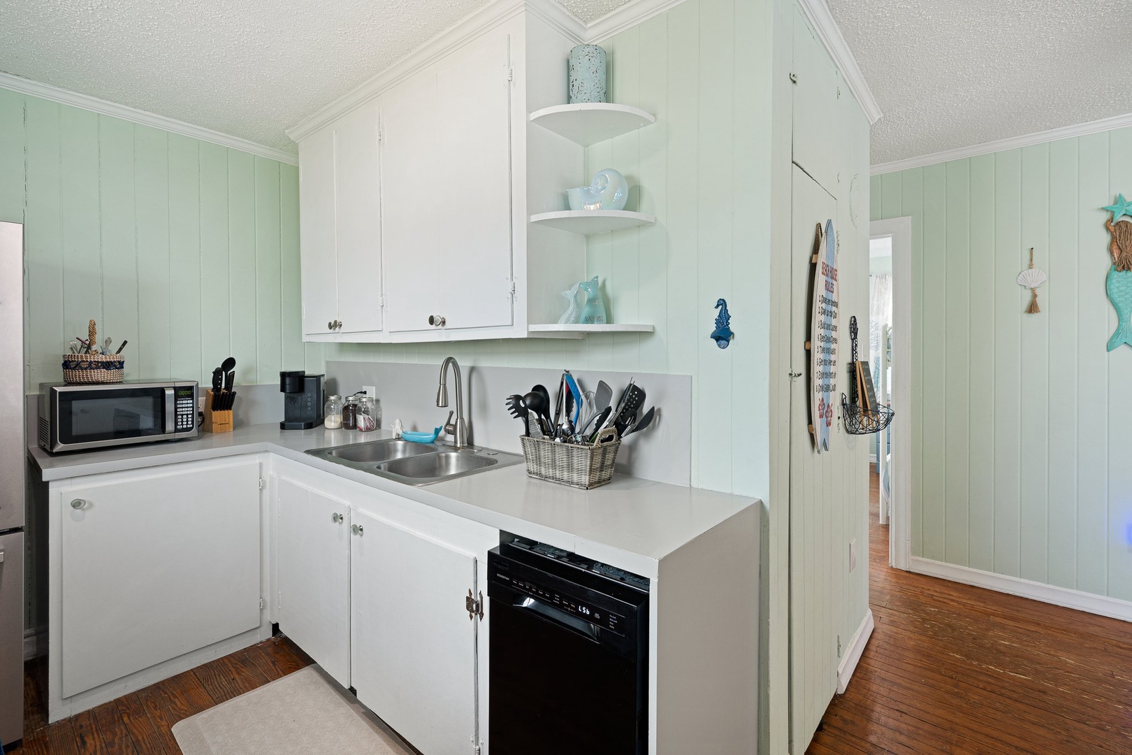 Your bright coastal kitchen awaits with everything you need - full appliances, plenty of counter space, and charming seaside touches.
