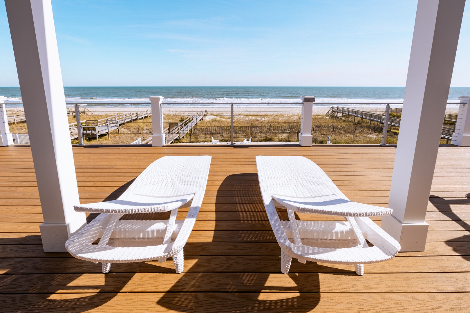 Soak up golden rays on your private deck as ocean waves dance before you, where morning coffee meets endless sea views.