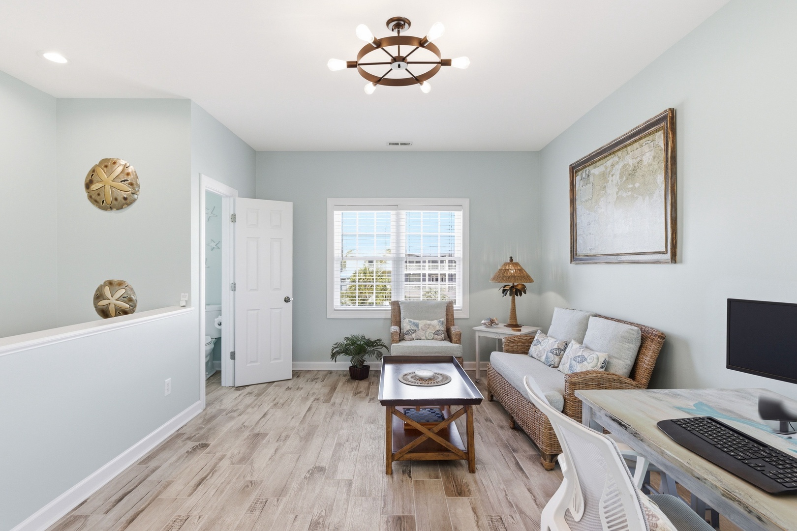 Your bright, coastal-inspired living room offers natural light, comfortable seating, and a peaceful spot to unwind after a day of exploring the nearby beaches and attractions.