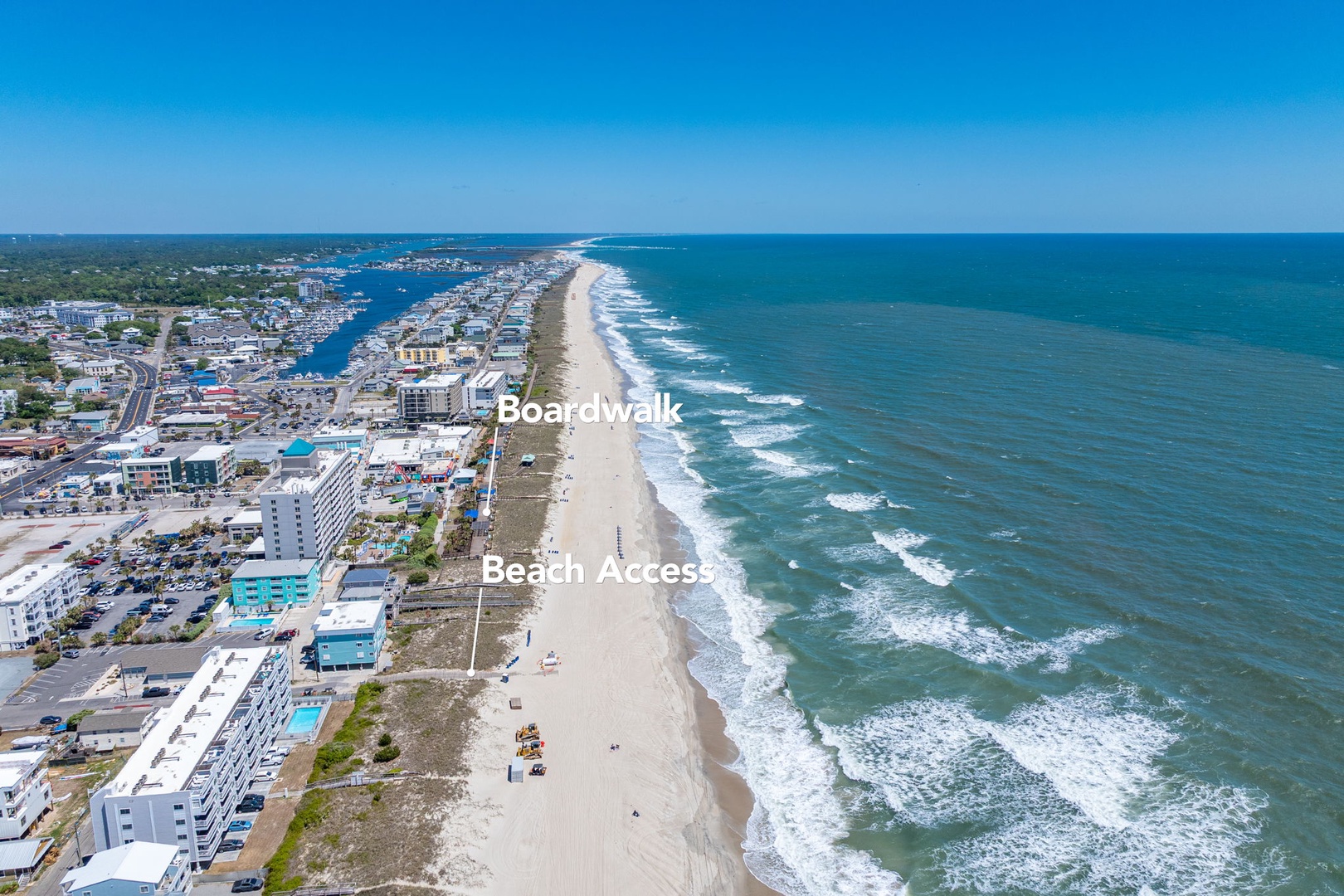 Aerial view showcasing the coastal town with pristine beaches, boardwalk attractions, and oceanfront access points.