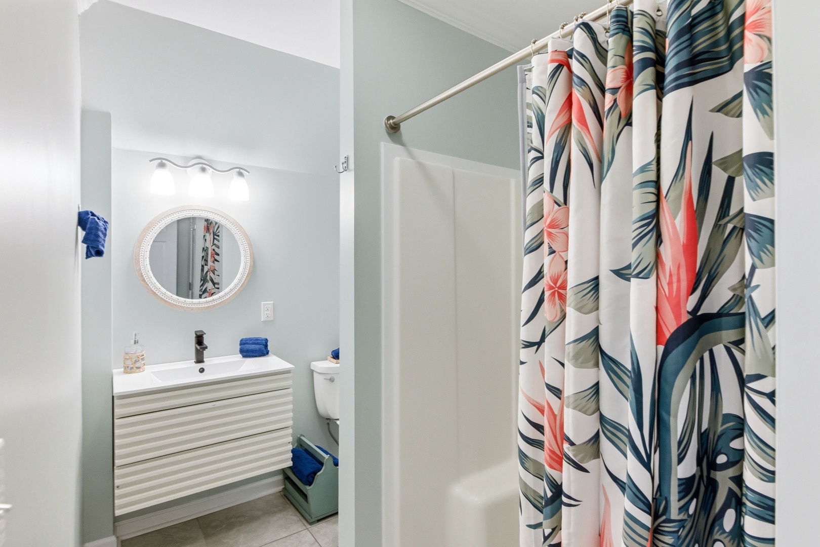 Your bright, welcoming bathroom features a modern vanity and tropical-inspired decor, creating a fresh, relaxing space to unwind after your adventures.