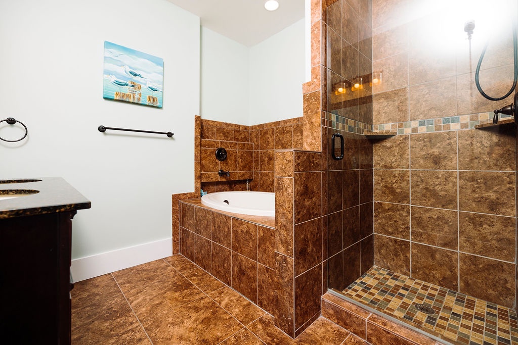 Luxurious marble bathroom with elegant soaking tub and spacious glass shower awaits your relaxing retreat.