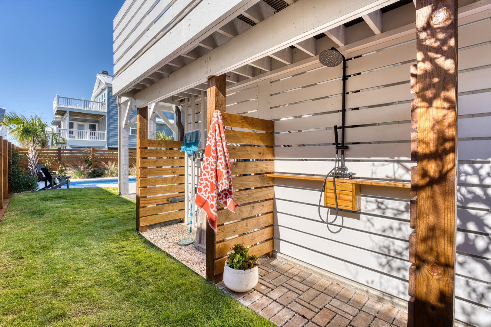 Rinse off salt and sand in your private outdoor shower, complete with warm wood accents and tropical views.