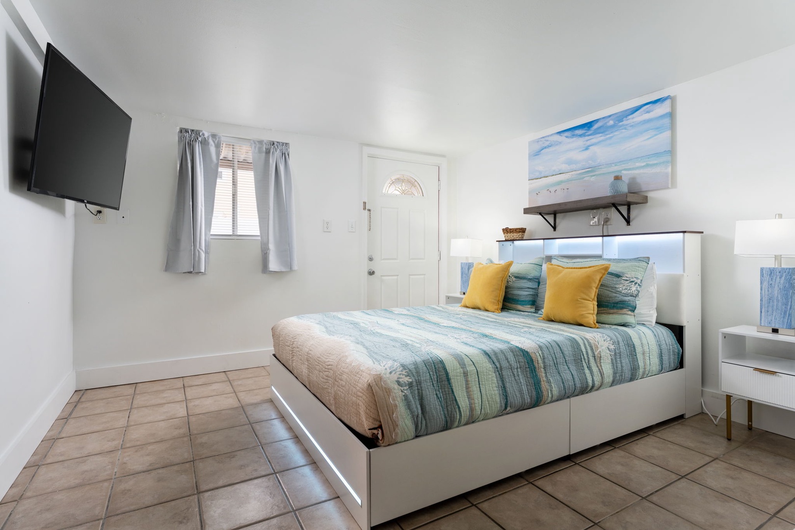 Drift off to sleep in your coastal-themed bedroom, where soft blue linens and ocean artwork create a peaceful seaside retreat.