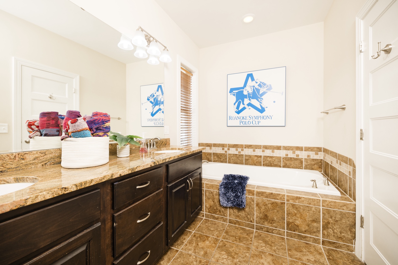 Unwind in your spacious bathroom with a luxurious soaking tub, granite countertops, and thoughtful amenities like fresh towels.
