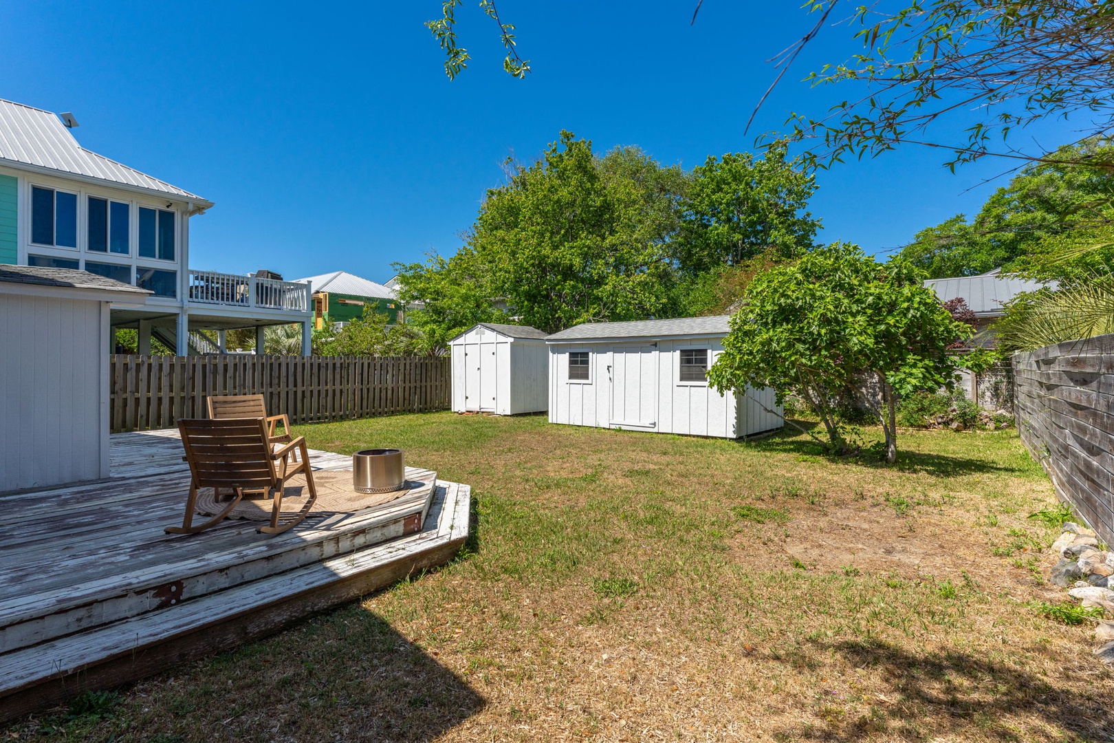 Relax on your private deck overlooking the spacious backyard, perfect for morning coffee or evening unwinding under the open sky.