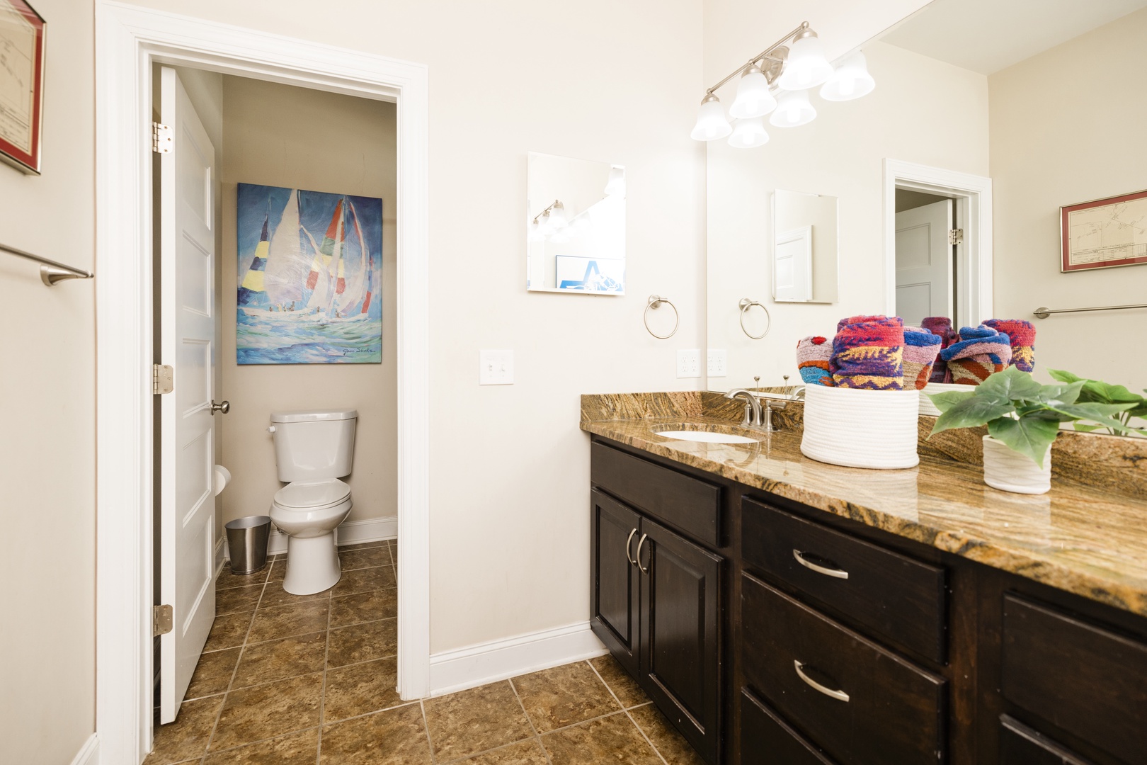 Your private bathroom features elegant granite countertops and thoughtful touches like fresh towels and coastal artwork to make you feel at home.