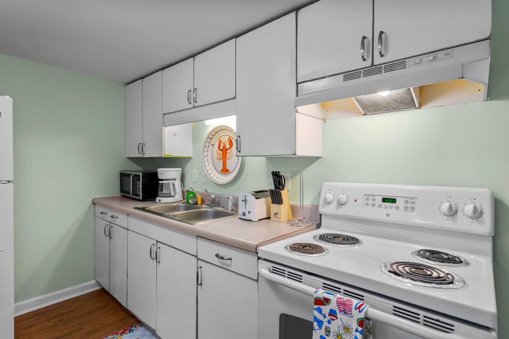 Your fully equipped kitchen awaits with modern appliances, ample storage, and charming coastal touches—perfect for preparing meals during your getaway.