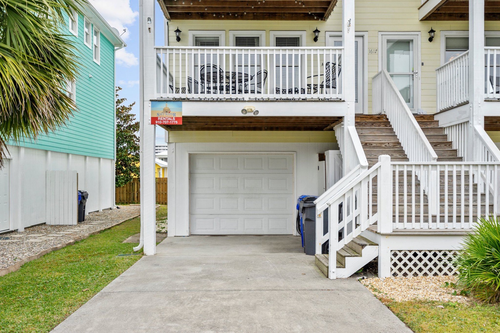 Bright coastal retreat with convenient garage parking and charming tropical surroundings in a vibrant neighborhood.