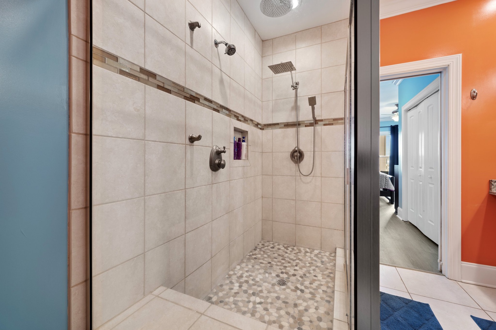 Step into your luxurious walk-in shower with dual rainfall heads and handheld sprays for the ultimate refreshing experience.