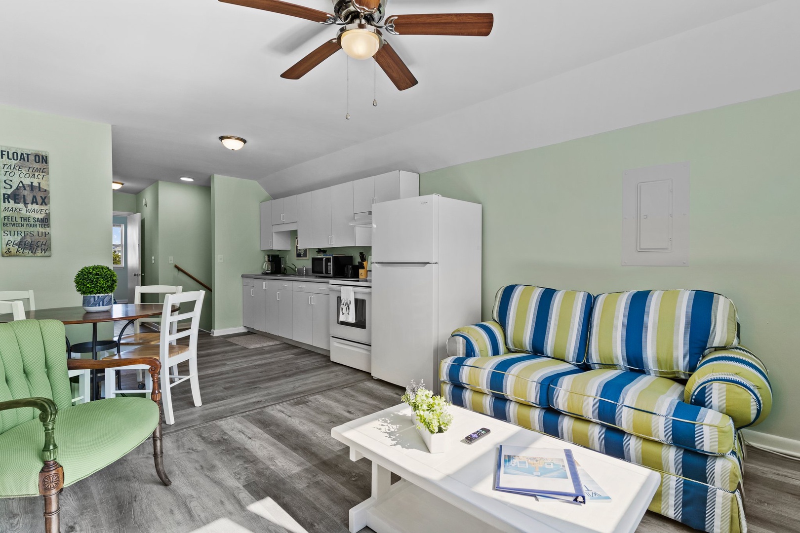 Unwind in your bright, airy retreat with a cozy striped sofa and fully equipped kitchen for all your vacation needs.