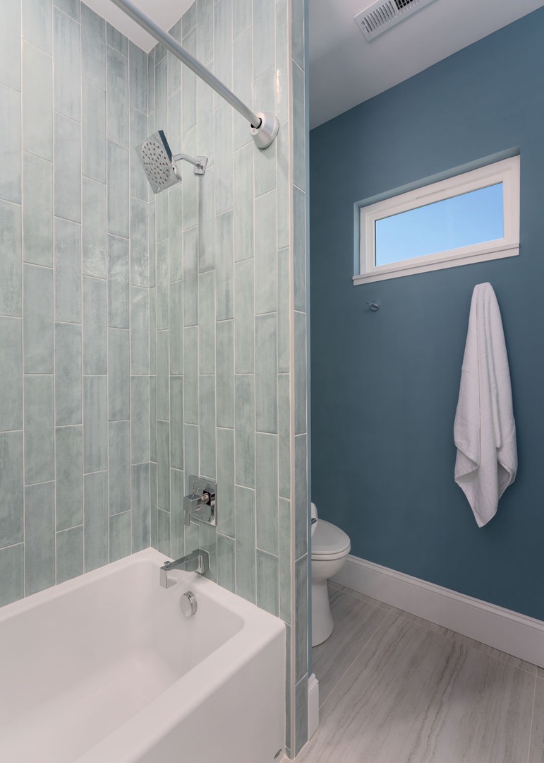 Step into your serene spa-like bathroom featuring stunning subway tiles and a refreshing teal accent wall that creates the perfect retreat.