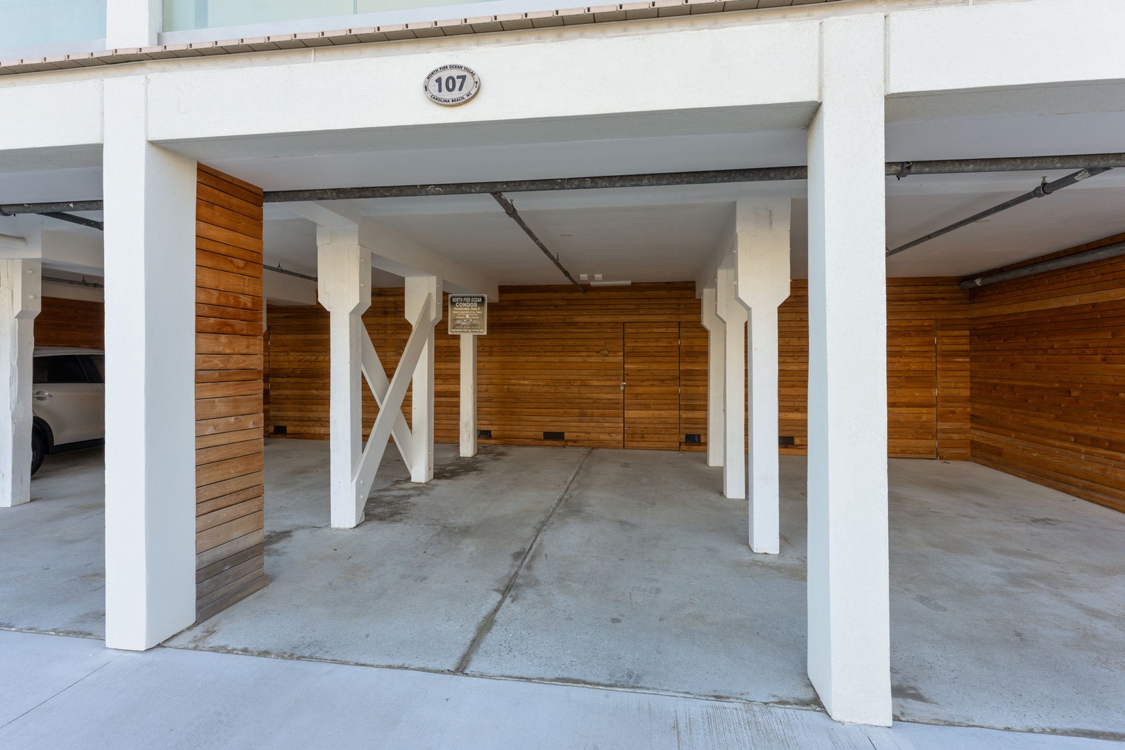 Secure covered parking space #107 with modern design and convenient ground-level access for easy unloading.