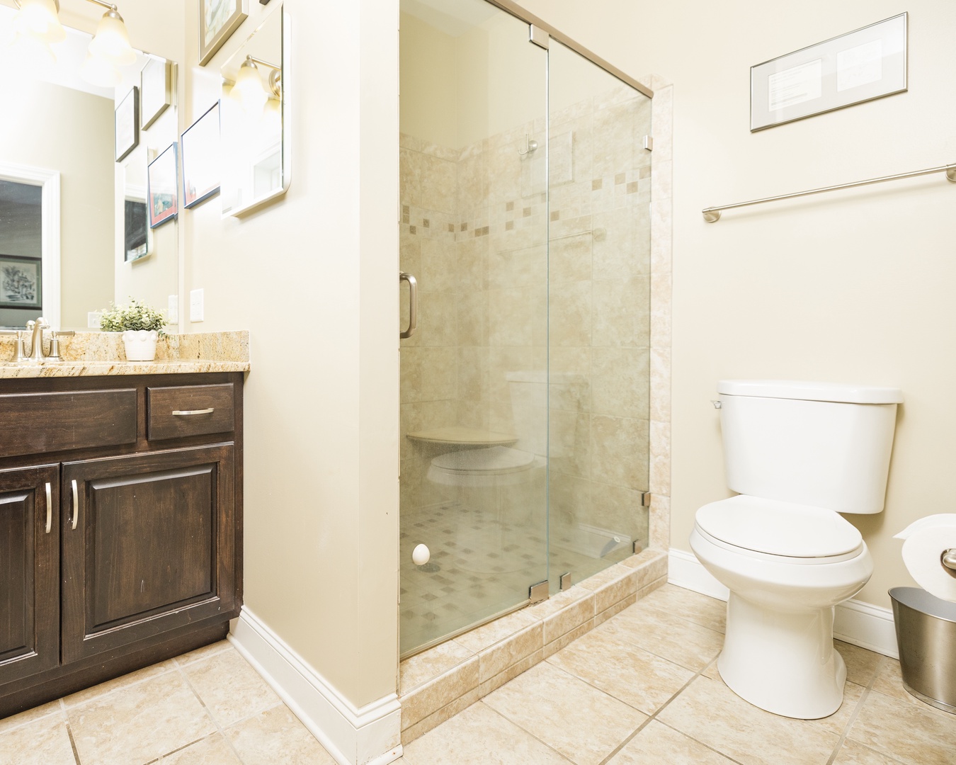 Refresh in your elegant bathroom with natural stone tiles, glass-enclosed shower, and granite vanity—a perfect retreat after your adventures.
