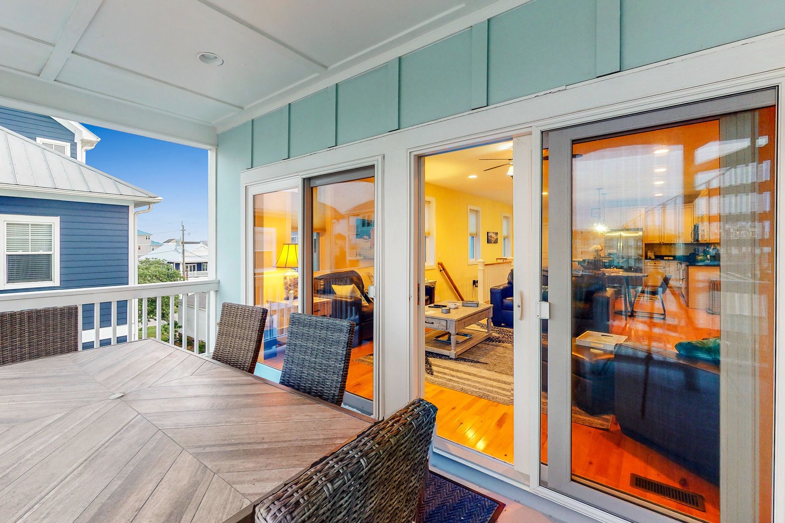 Step onto your private balcony where wicker chairs invite you to relax while enjoying coastal breezes and charming neighborhood views.