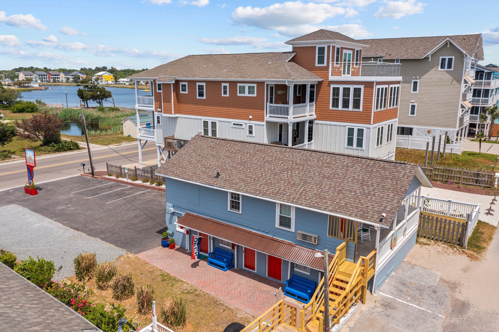 Colorful beach house with elevated wooden walkway, just steps from waterfront activities in this charming coastal community.