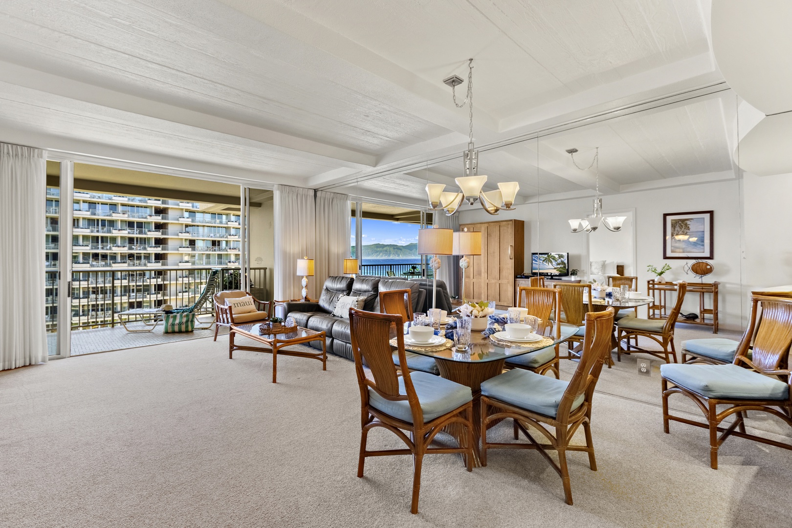 Welcoming dining area adjacent to a fully equipped kitchen, featuring bar seating, warm wood cabinetry, and an open layout ideal for gatherings.