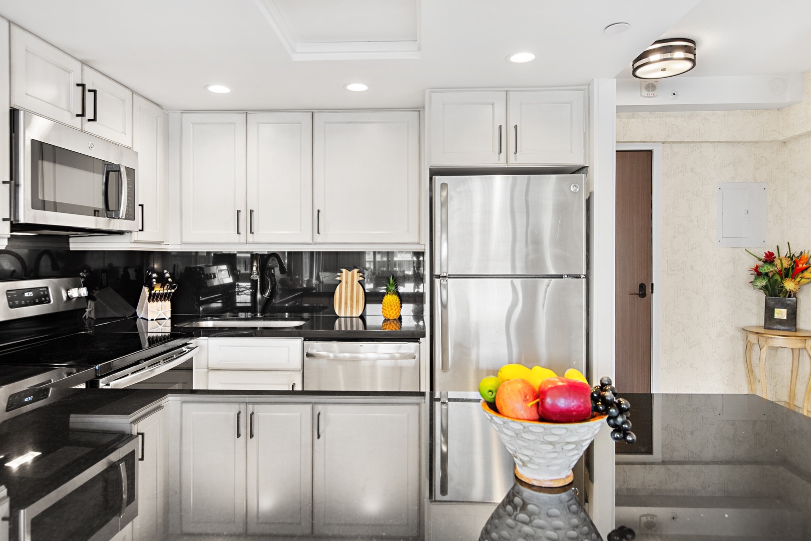 Step into your bright, modern kitchen with sleek white cabinetry, granite countertops, and stainless steel appliances. Fresh touches await, making it easy to prepare your favorite meals in style.