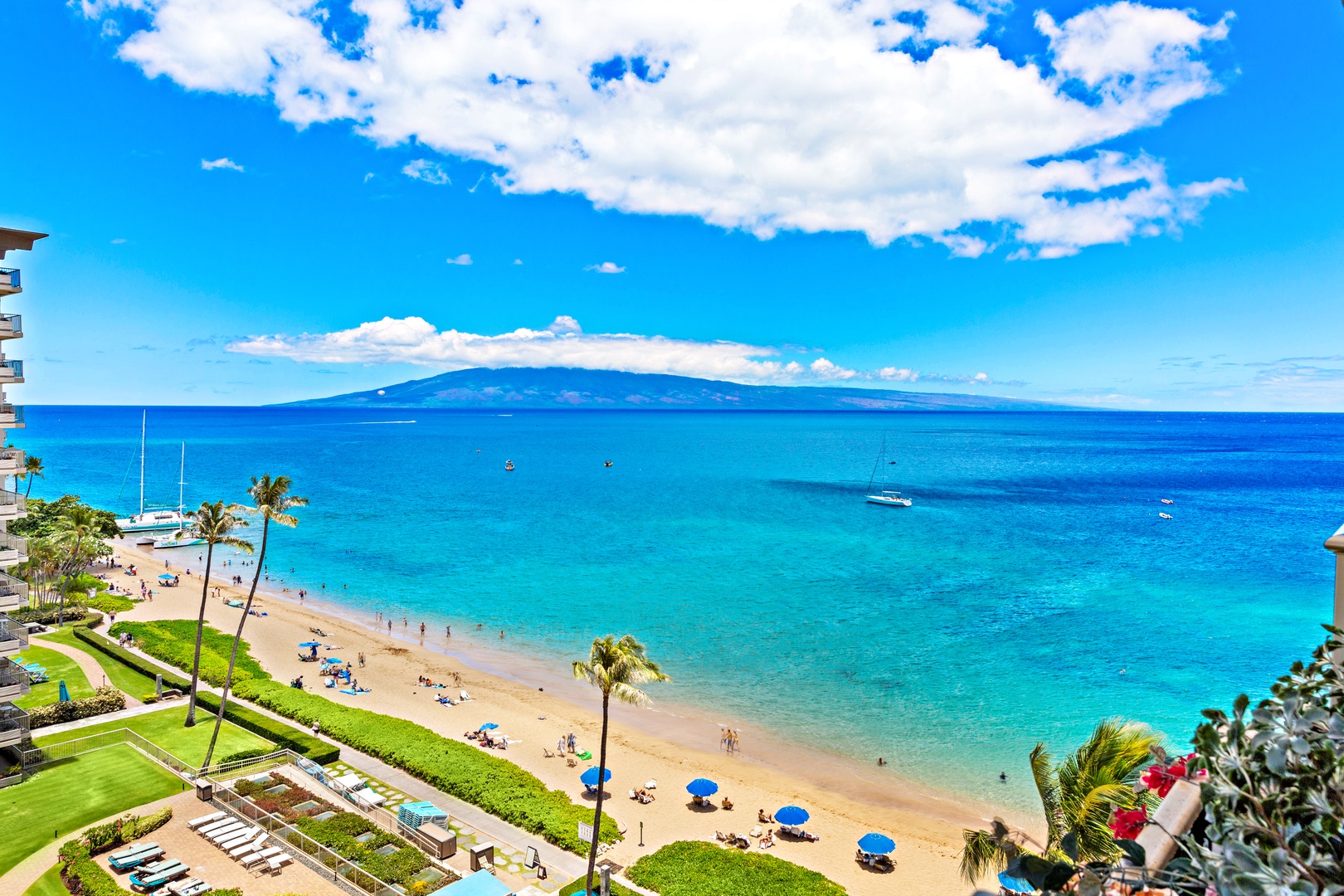 This beachfront property offers direct access to pristine golden sands and stunning turquoise waters, with an island rising majestically on the horizon—an idyllic Hawaiian escape awaits.
