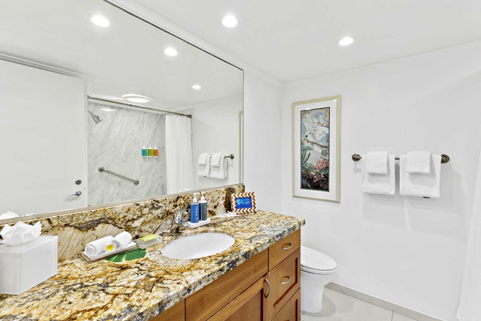 Your private bathroom features elegant granite countertops, pristine white finishes, and a refreshing walk-in shower—perfect for unwinding after your adventures.