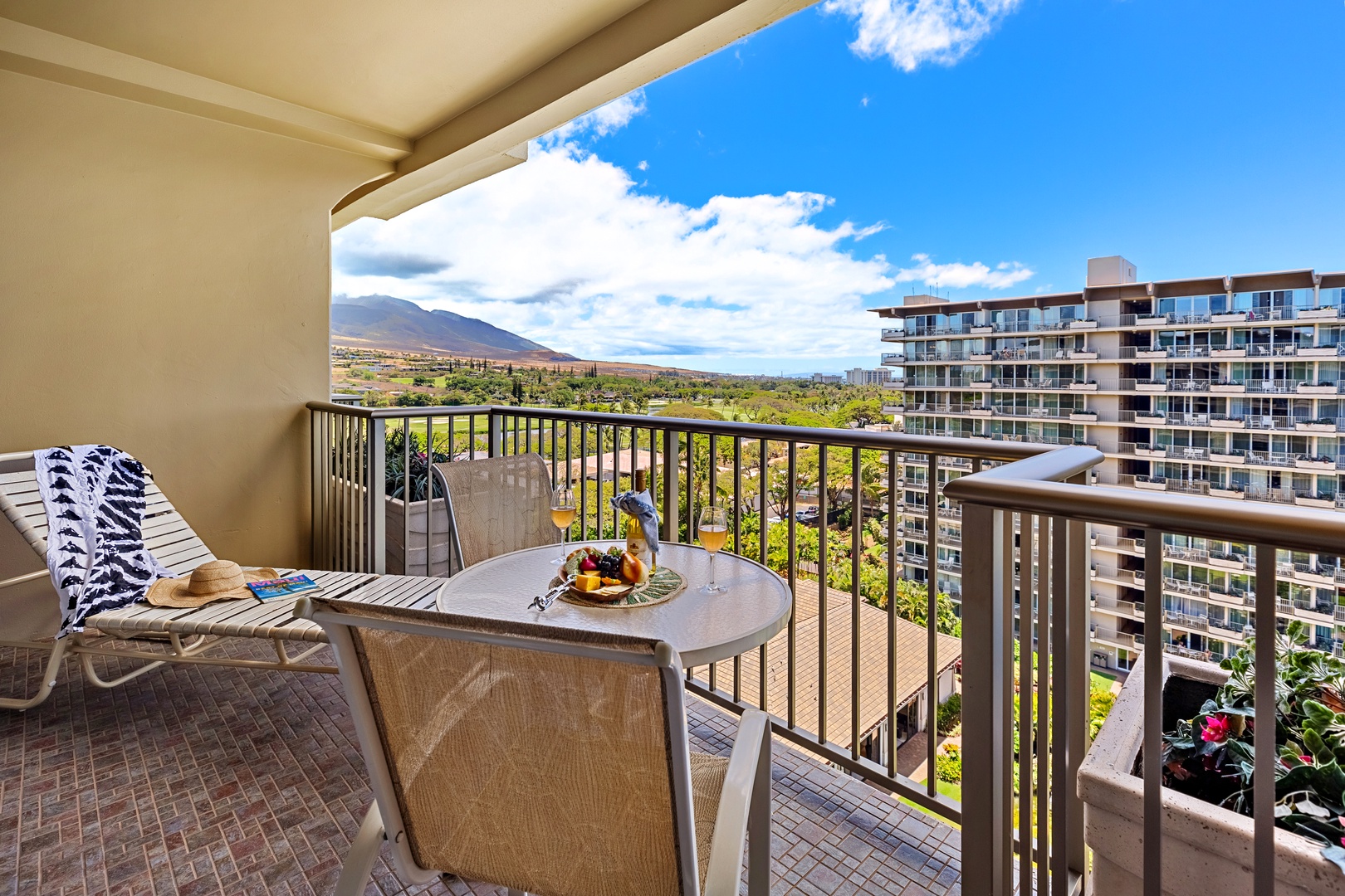 Serene mountain views right from your private balcony. Unwind in comfortable outdoor seating as the island’s lush peaks and golden skies create the perfect peaceful escape.