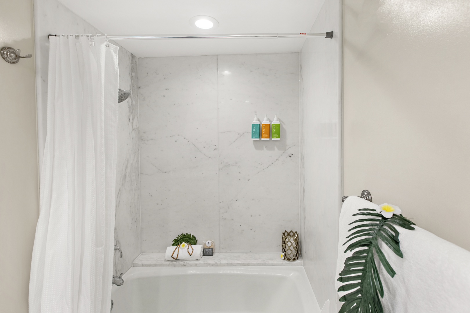 Step into your pristine marble bathroom with luxurious tub-shower combo, premium toiletries, and spa-like ambiance for ultimate relaxation.