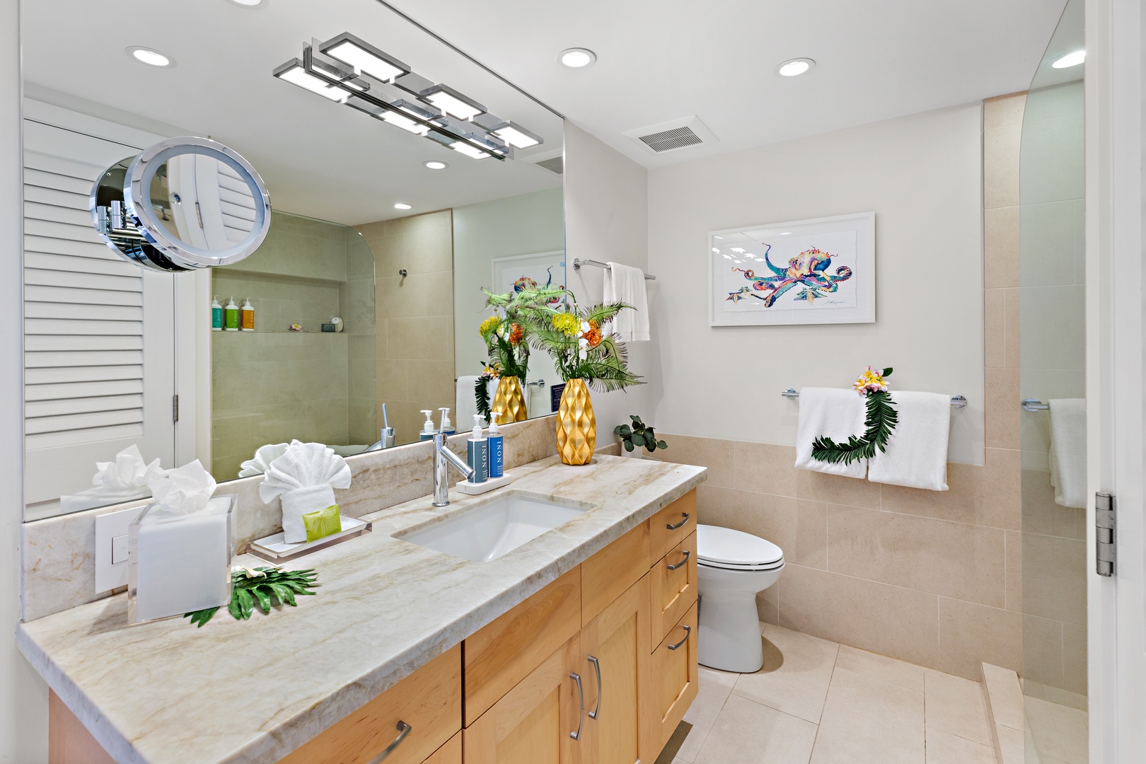 Step into your elegant bathroom where natural light and tropical touches create a spa-like retreat. Marble countertops and warm wood cabinetry blend luxury with comfort for your perfect getaway.