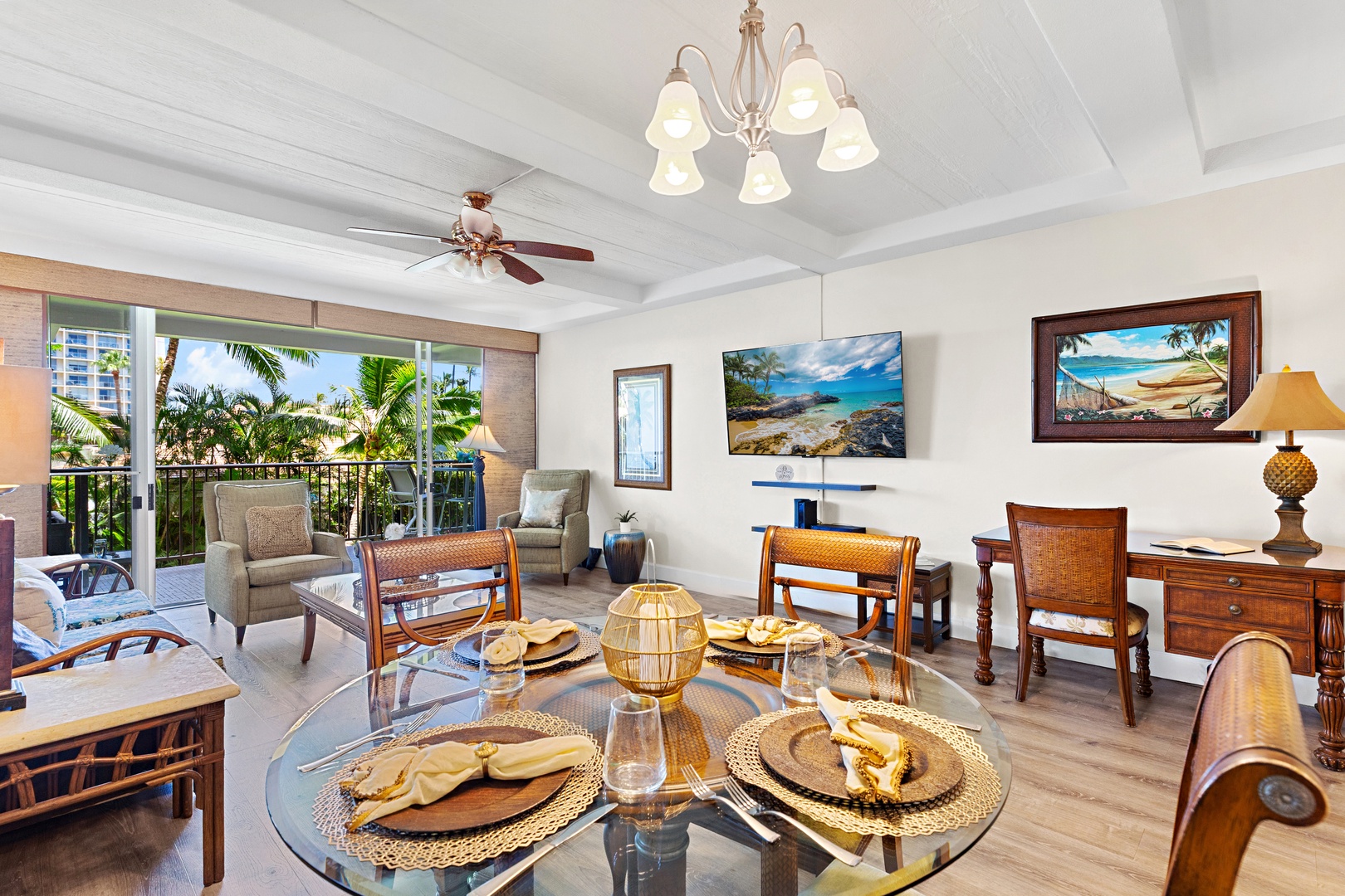 Picture yourself in this inviting living space where island breezes drift through the balcony doors. Relax in comfortable seating under vaulted ceilings, gather around the dining table, and feel right at home with tropical décor welcoming you to paradise.