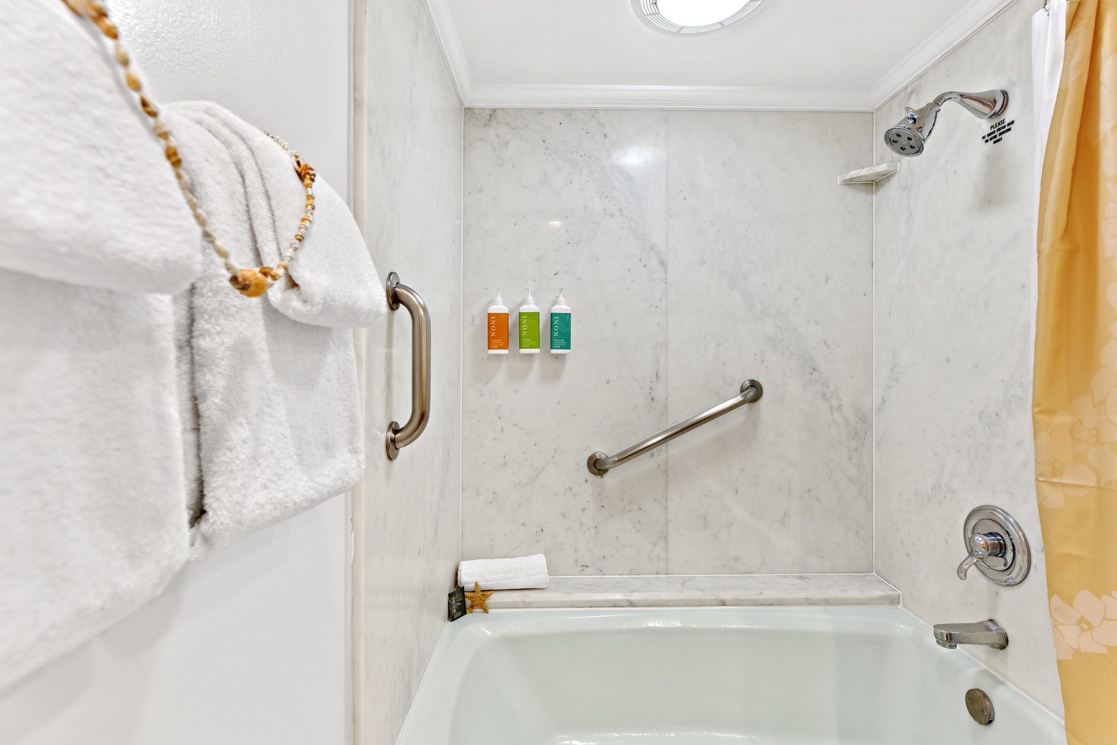 Unwind in your spa-like bathroom with marble-style walls, grab bars for safety, premium toiletries, and plush towels waiting for you.