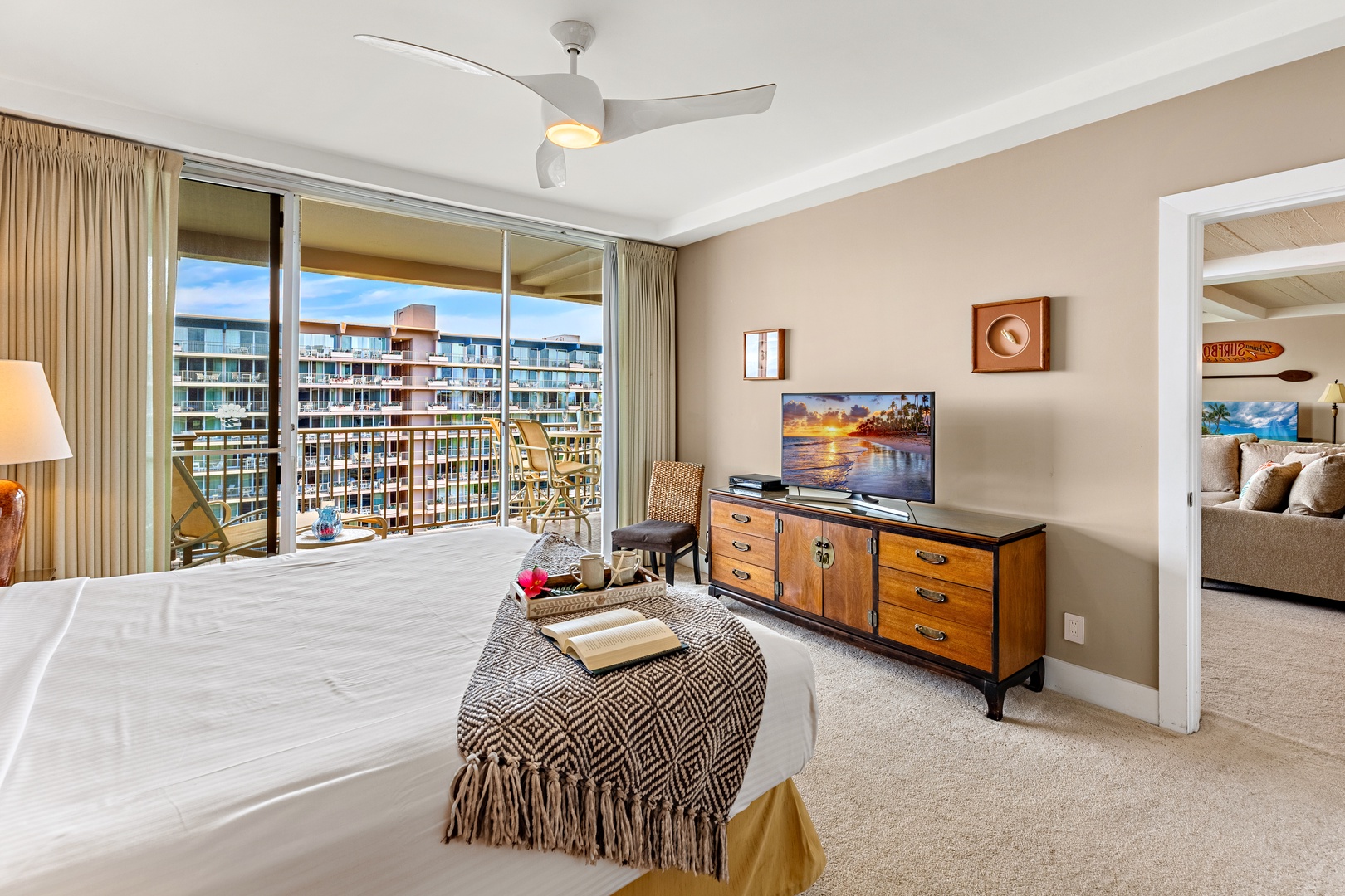 Unwind in your bright master bedroom with plush bedding, modern amenities, and a stunning balcony overlooking the resort.