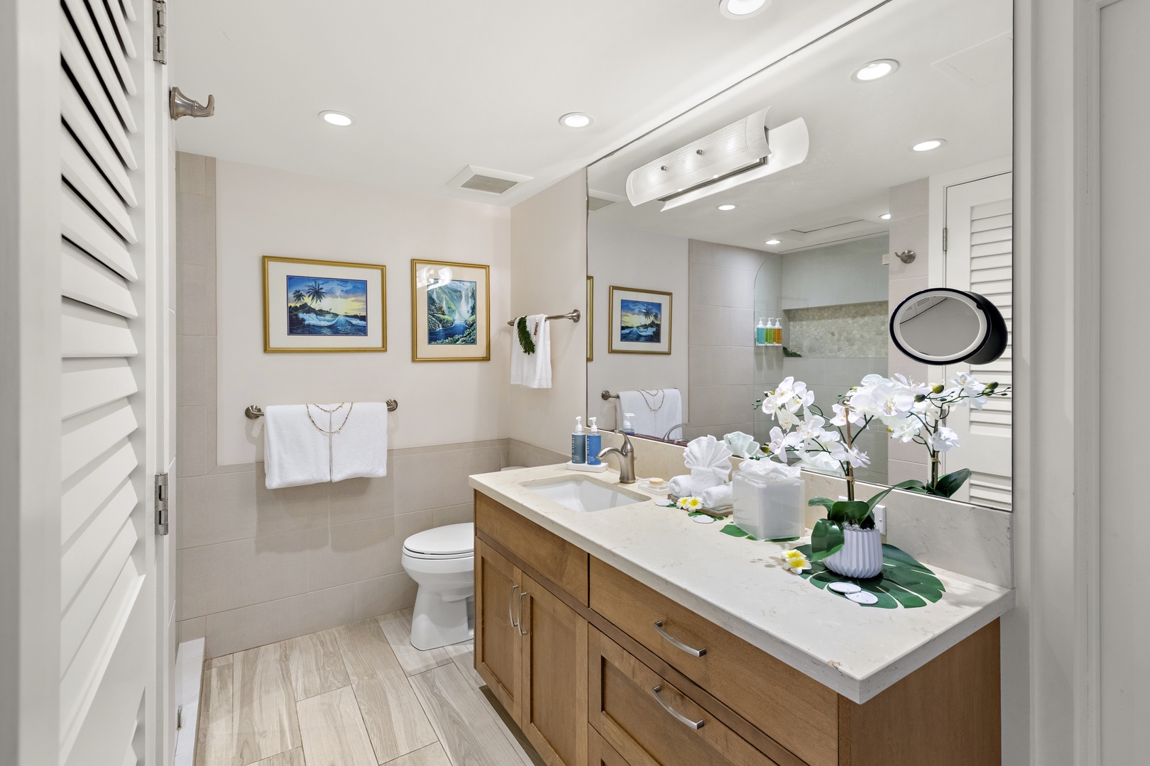 Spacious bathroom with double vanity, granite countertops, and ample lighting, designed for both style and convenience.