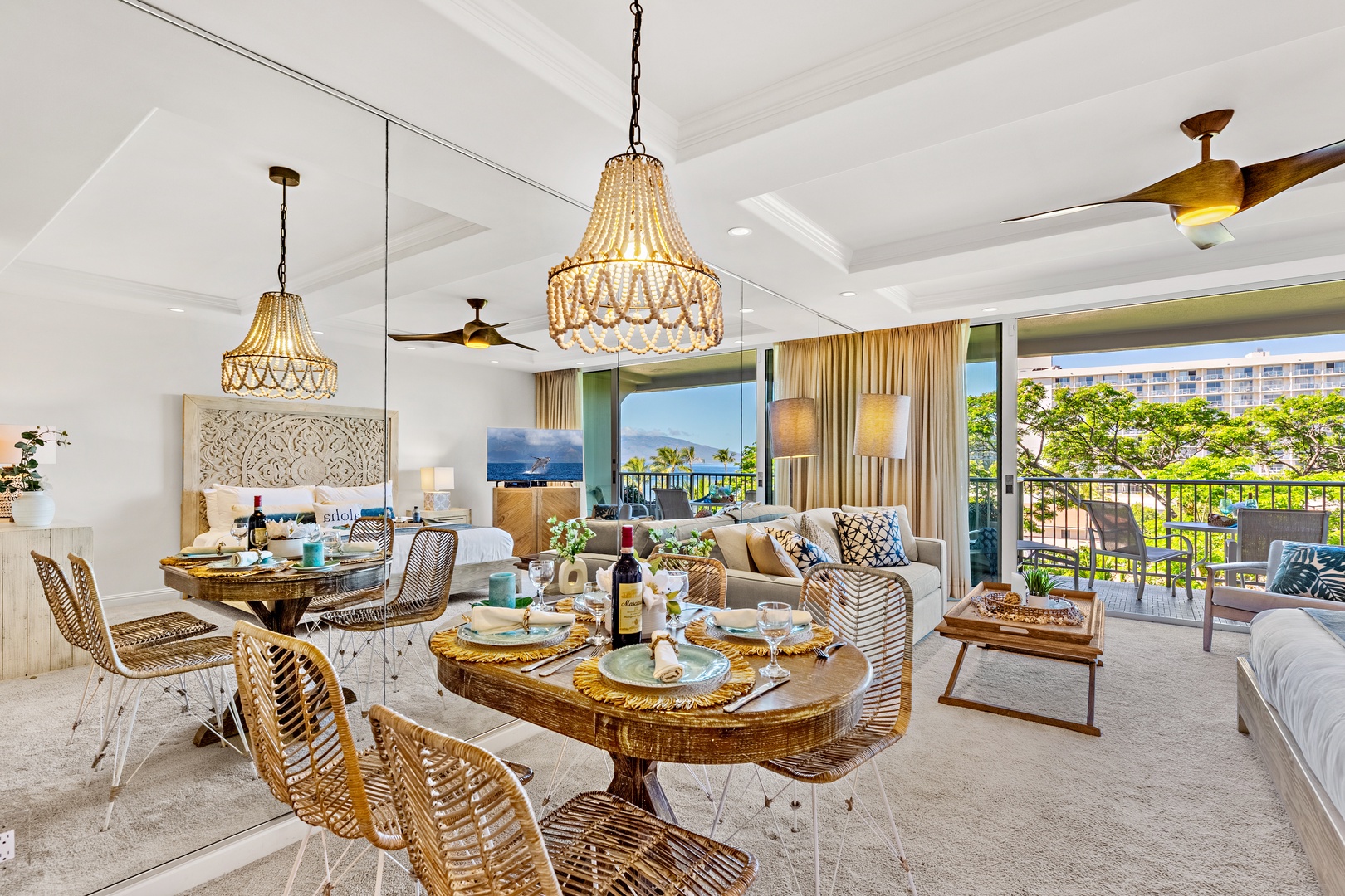 Step into your sunlit, open-plan sanctuary with tropical views framing the room. Relax at the elegant dining table, unwind on plush sofas, or retreat to the inviting bedroom—all styled with coastal charm and comfort.