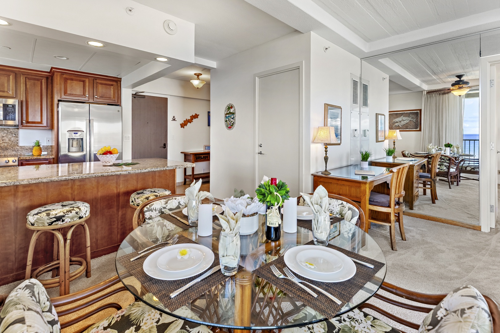 Gather around this welcoming dining space for shared meals and conversations. The open layout connects the kitchen and living areas, creating an inviting atmosphere perfect for your coastal getaway.