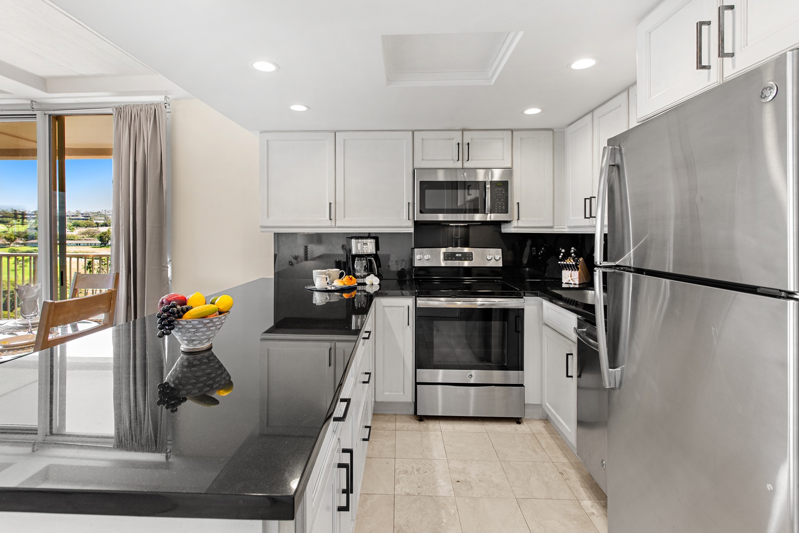 Your modern kitchen awaits with sleek countertops, stainless steel appliances, and a breakfast bar overlooking the balcony—perfect for morning coffee with sunlight streaming in.