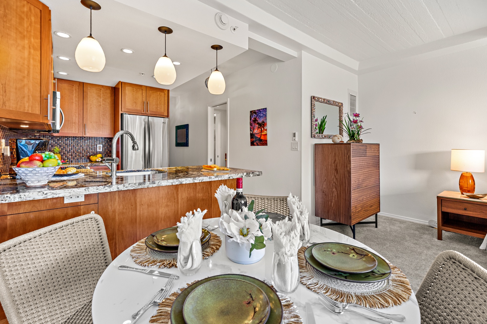 Gather around this elegant dining area where your group can share meals together. The open layout connects you to the full kitchen, perfect for hosting memorable dinners in your home away from home.