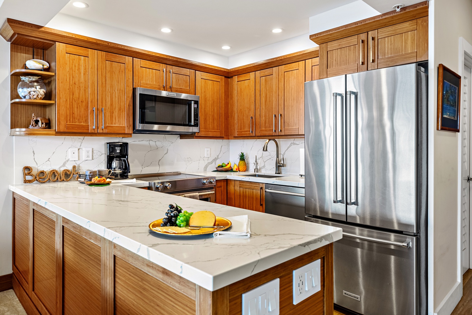 Your fully equipped gourmet kitchen awaits with rich wood cabinetry, gleaming granite counters, and stainless steel appliances for memorable vacation meals.