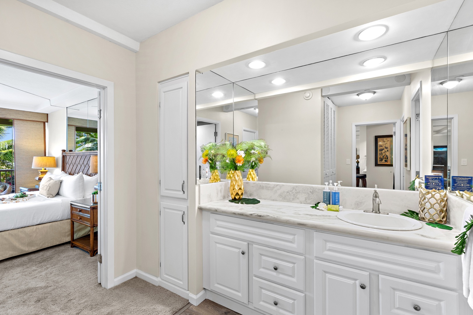 Your bright en-suite bathroom features elegant marble countertops, ample storage, and fresh florals to start each morning refreshed and ready for island adventures.