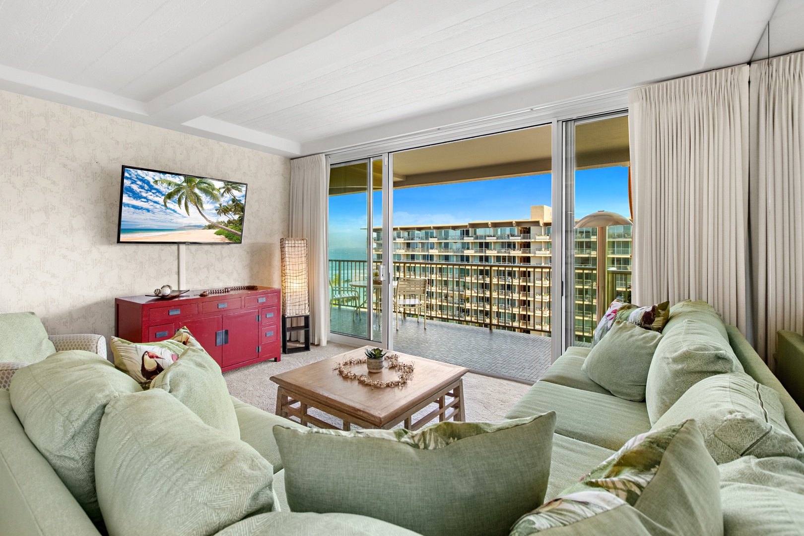 Sink into plush seating and gaze out at blue skies through sliding glass doors that open to your private balcony, where water and coastal views await you.