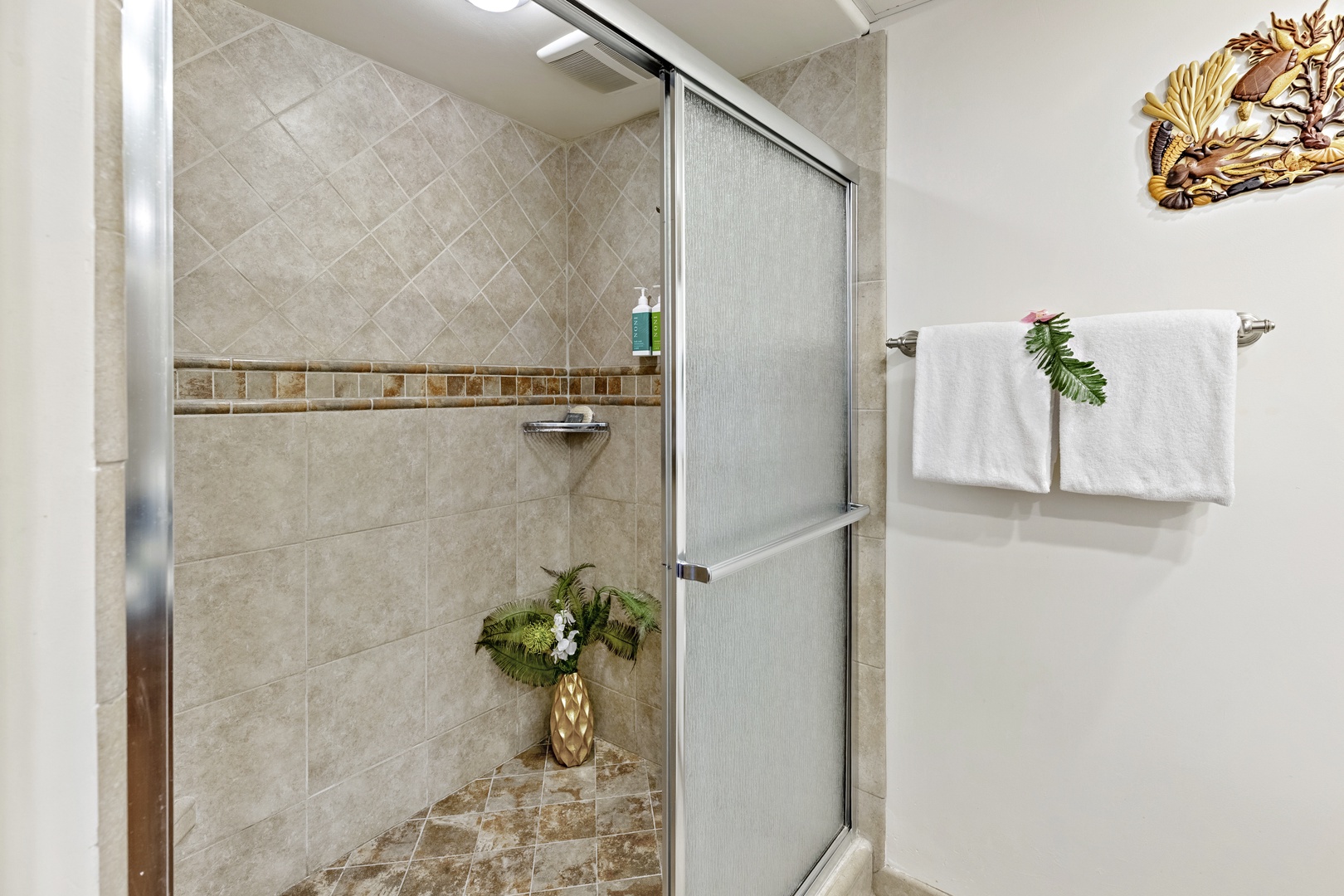 Step into your private spa-like shower with elegant tiling and fresh towels waiting. This serene space invites you to unwind and refresh in comfort and style.