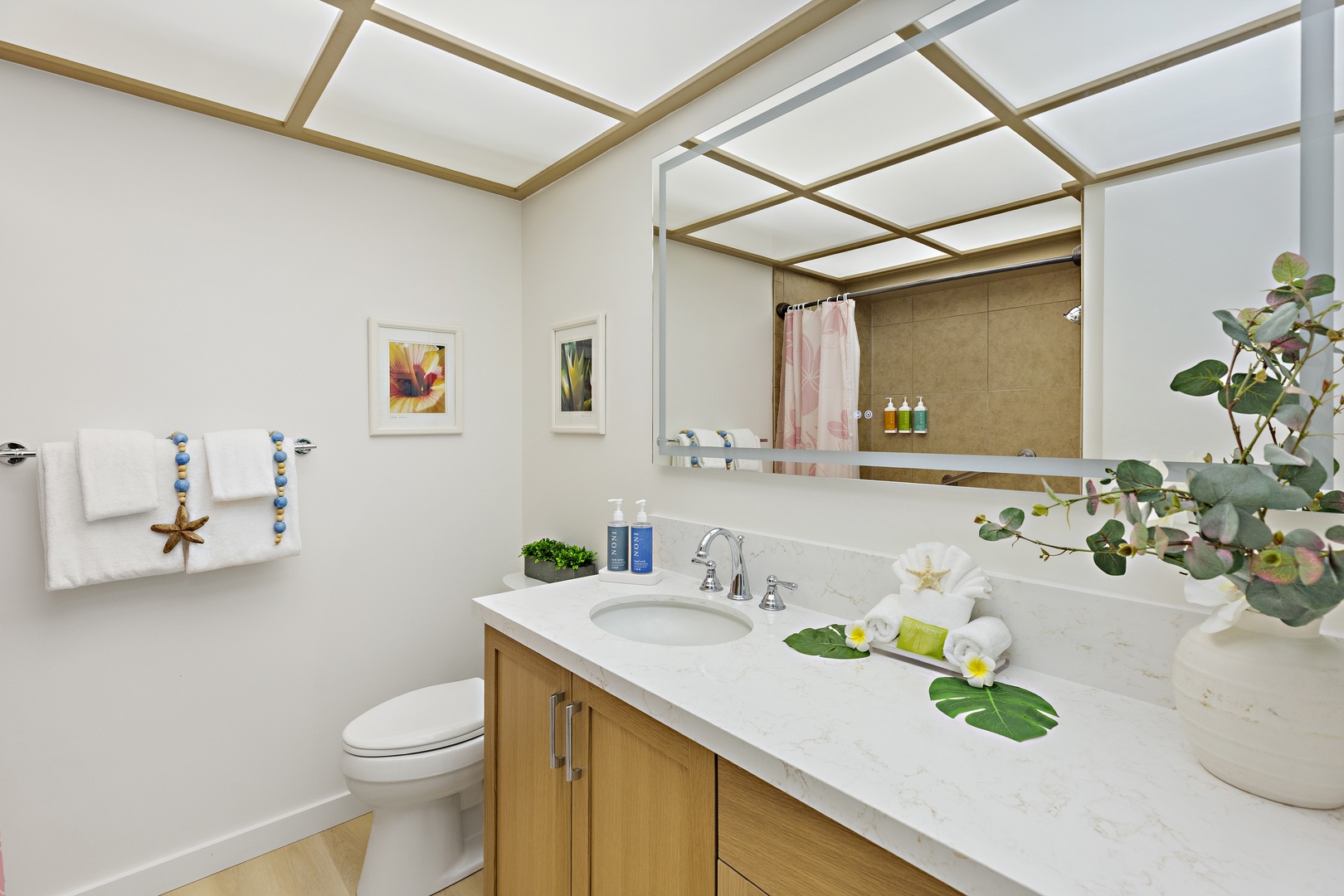 Step into your spa-like bathroom featuring a sleek vanity, luxurious quartz countertops, and tropical-inspired touches that make freshening up feel like a mini retreat.